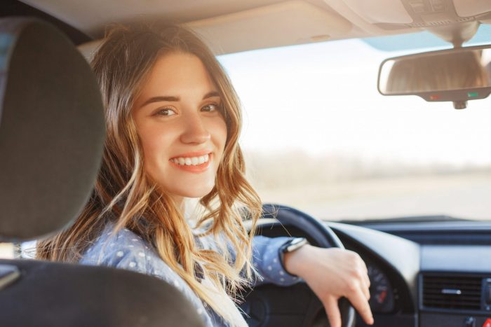 Photo of woman smiling in car illustrates blog: "Full Auto Insurance Coverage in Houston Texas: What You Need To Know"