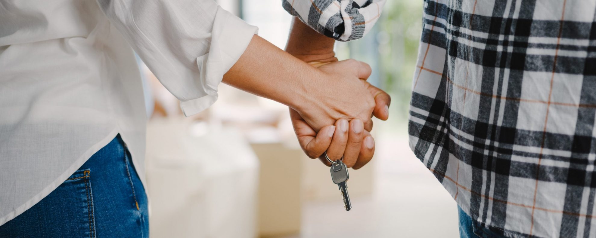 Photo of couple holding hands with keys hanging from their fingers illustrates blog: "HO3 vs HO5 Policies: What Is the Difference?"